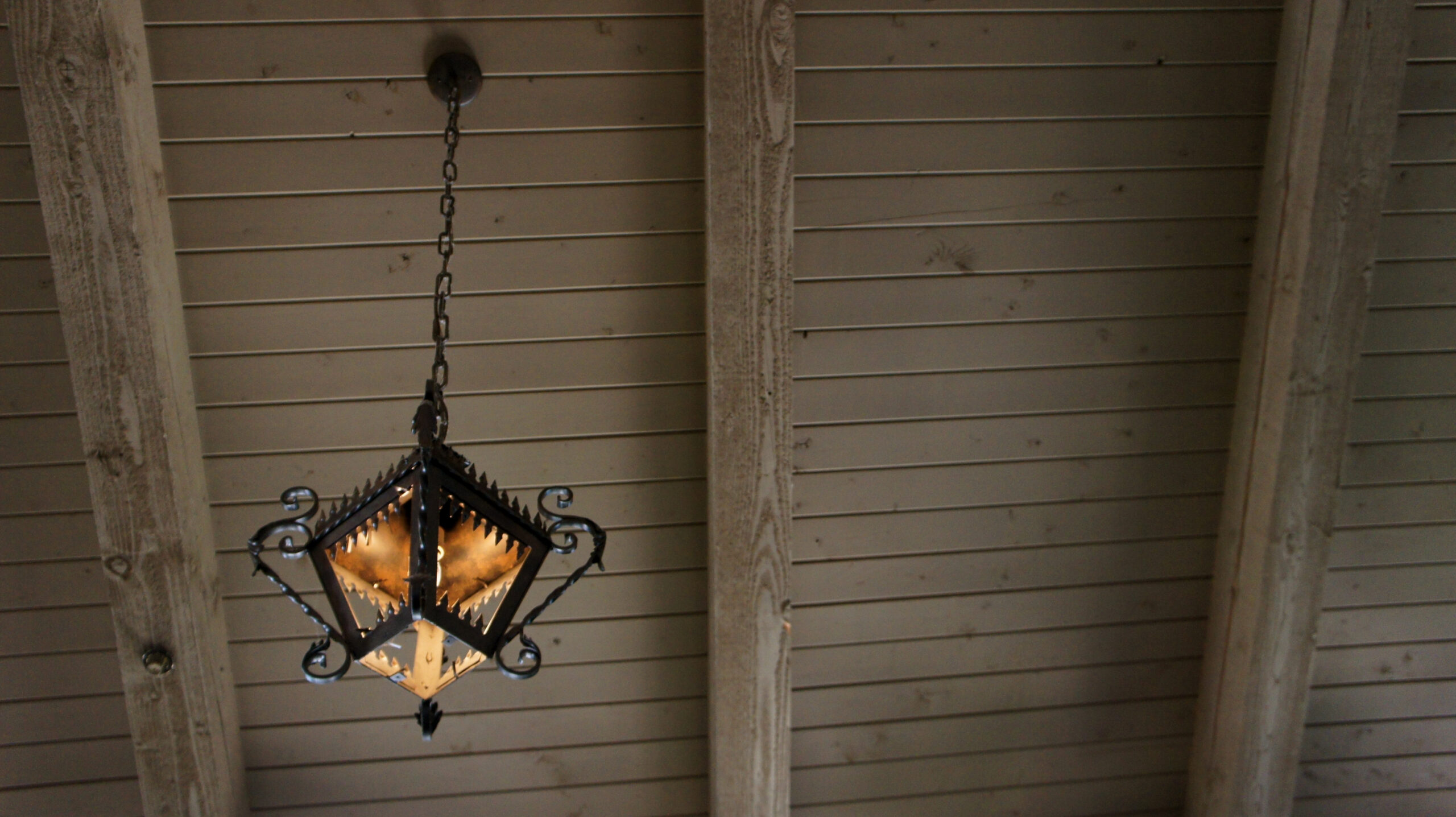 Iron works light fixture chandelier barn wood ceiling